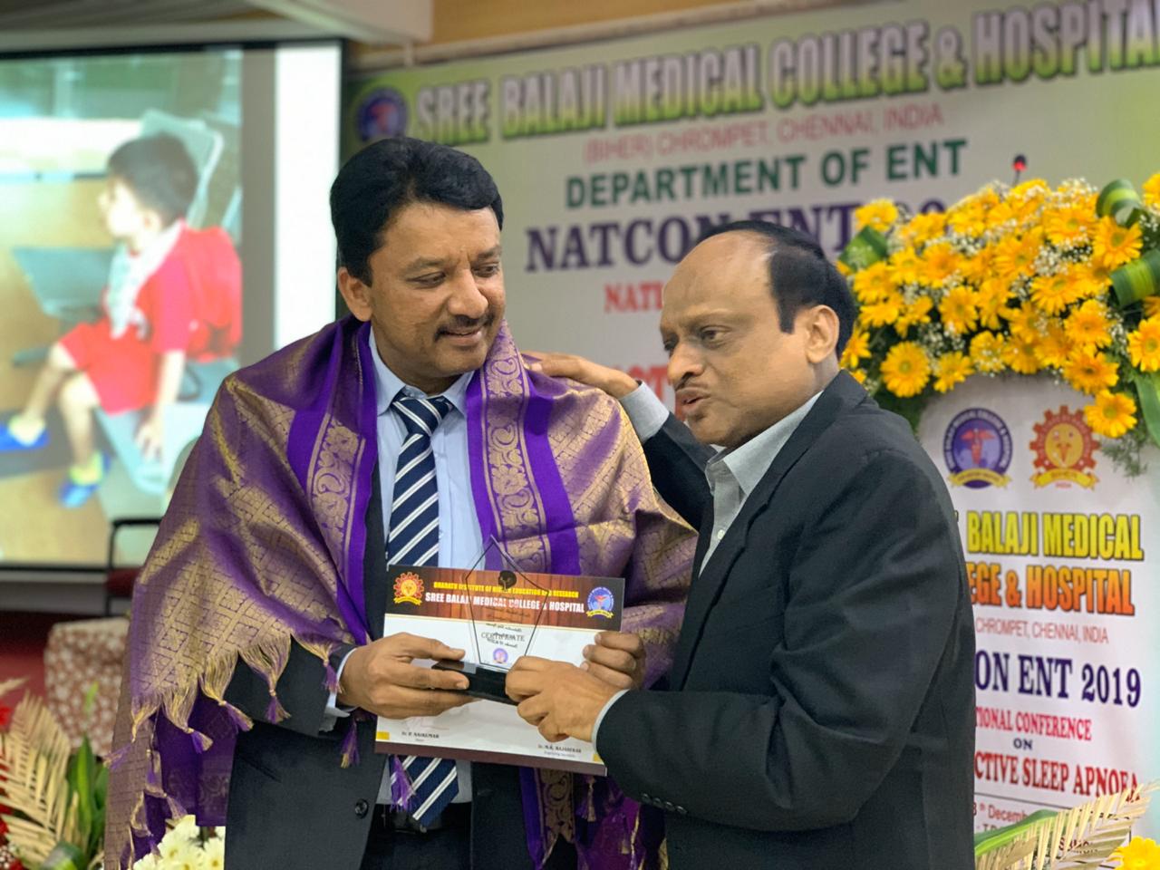 Dr SM Balaji receiving certificate of participation